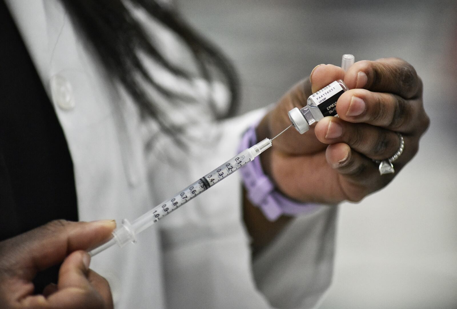 Kroger nurse practitioner Amanda Flowers prepares Covid-19 vaccines to be administered to school staff Wednesday, February 3, 2021 at Lakota West High School in West Chester Township. NICK GRAHAM / STAFF