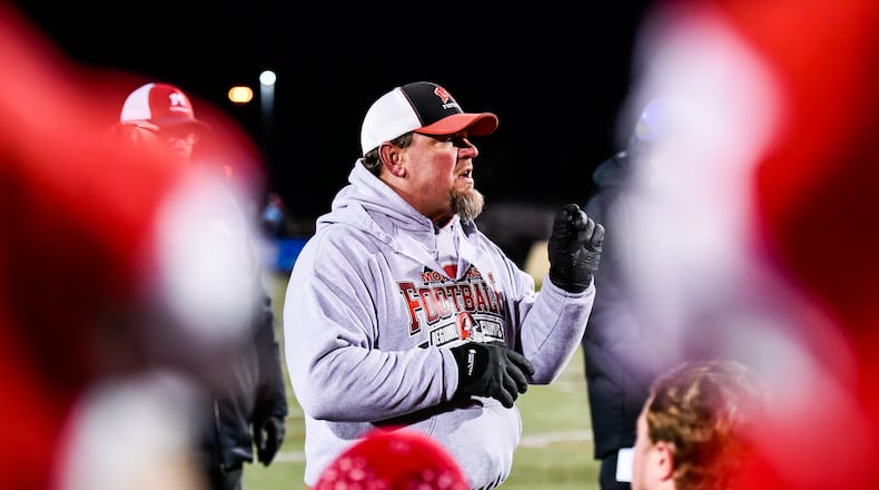 Madison football coach Steve Poff speaks to the team after its 50-6 win over Cincinnati Hills Christian Academy in a Division V, Region 20 football semifinal Nov. 10 at Lakota East. NICK GRAHAM/STAFF