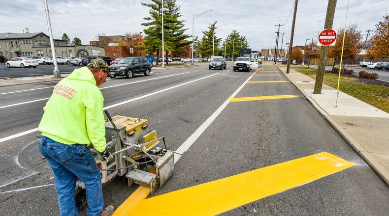 Bo Starcher with Aero-Mark pavement marking specialists puts down lines to take Verity Parkway down to two lanes in sections of downtown Middletown Wednesday, Nov. 6, 2019. NICK GRAHAM/STAFF