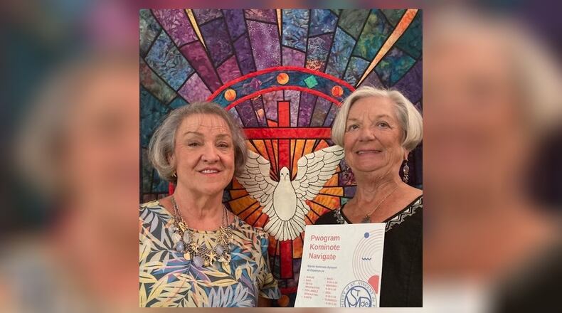 Nurse Connie Mitchell, right, holds a Creole language flier with Pastor Vicki Downing in the sanctuary of Springfield's Grace United Methodist Church. (Photo:
TOM STAFFORD)