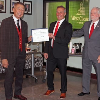 West Chester Twp. trustee Mark Welch, center, received a certificate of recognition during a gathering before his last board of trustees meeting. It was presented by Trustee Lee Wong, left, and Fiscal Officer Bruce Jones. Welch did not win re-election to a fourth term in the November election. SUE KIESEWETTER/CONTRIBUTED