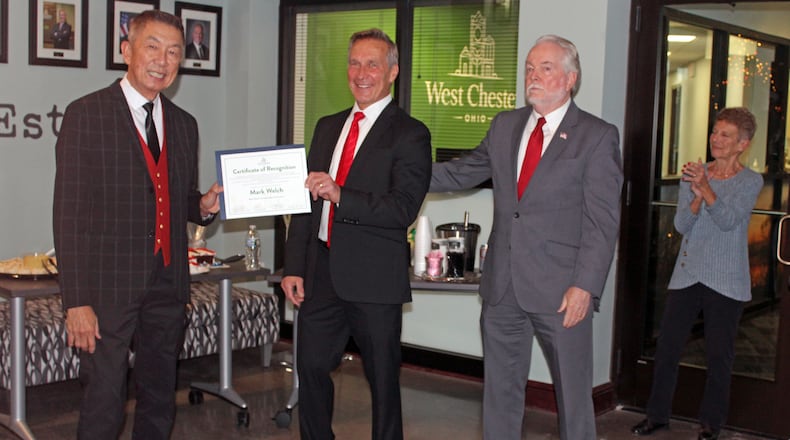 West Chester Twp. trustee Mark Welch, center, received a certificate of recognition during a gathering before his last board of trustees meeting. It was presented by Trustee Lee Wong, left, and Fiscal Officer Bruce Jones. Welch did not win re-election to a fourth term in the November election. SUE KIESEWETTER/CONTRIBUTED