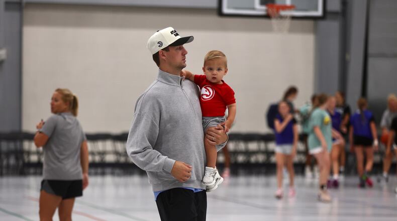 Luke Kennard carries his son Porter at the Luke Kennard Elite Basketball Camp on Saturday, July 19, 2025, at Camp Chautauqua in Miamisburg. David Jablonski/Staff