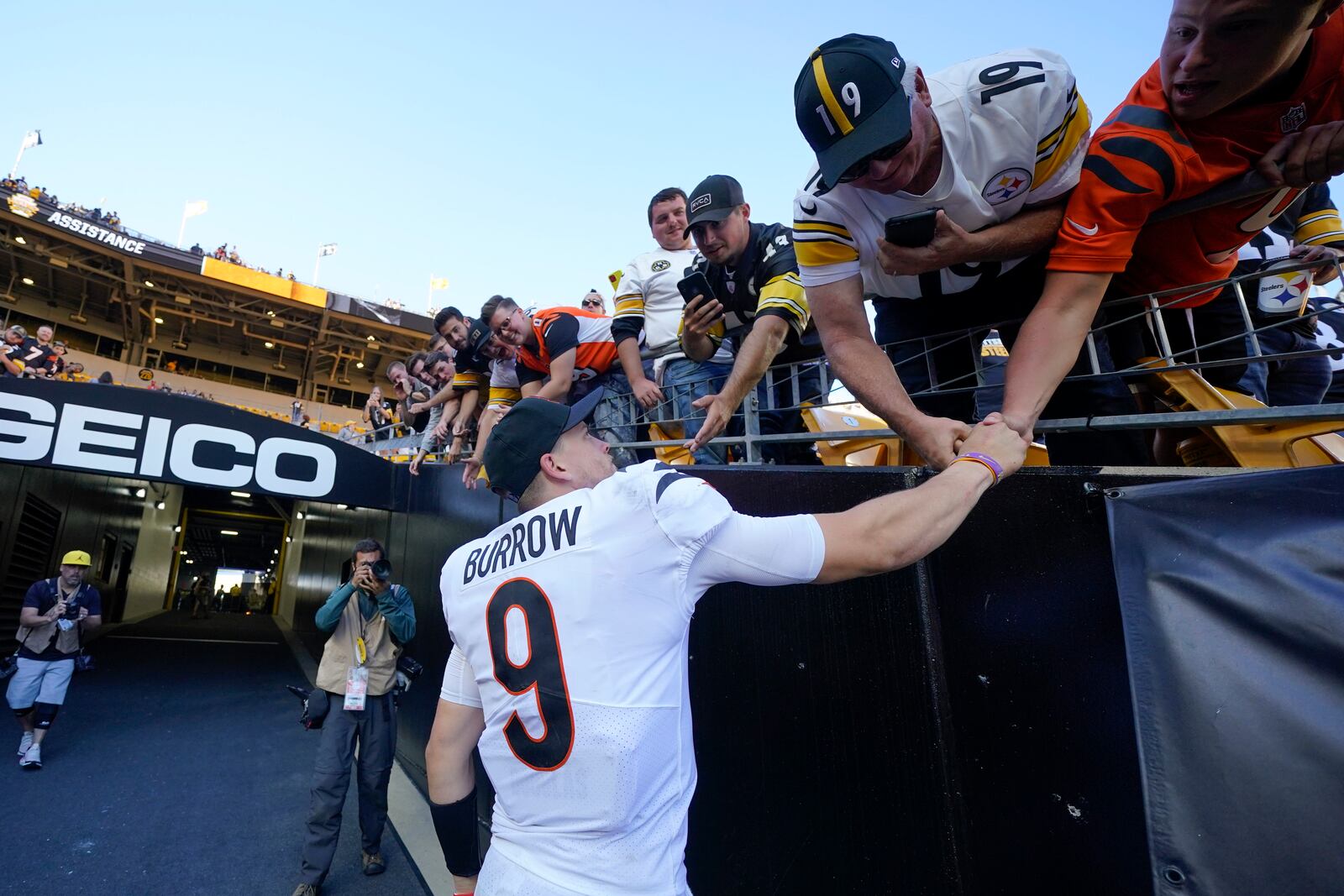 Cincinnati Bengals quarterback Joe Burrow (9) greets fans after defeating the Pittsburgh Steelers in an NFL football game, Sunday, Sept. 26, 2021, in Pittsburgh. The Bengals won 24-10. (AP Photo/Gene J. Puskar)