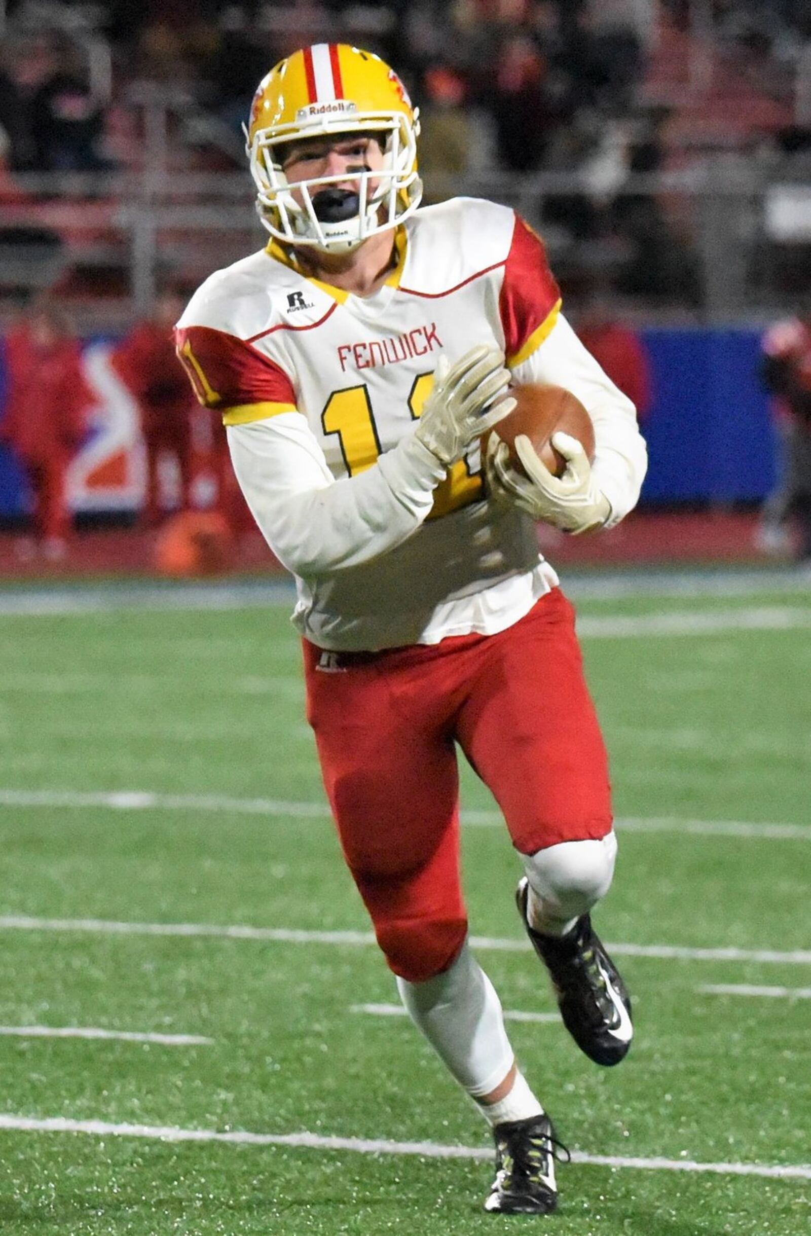 Fenwick’s Thomas Vogelsang (11) heads down the field during Friday night’s Division III, Region 12 playoff semifinal against Wapakoneta at Piqua’s Purk Field at Alexander Stadium. Vogelsang had two receptions for 50 yards in the game. CONTRIBUTED PHOTO BY ANGIE MOHRHAUS
