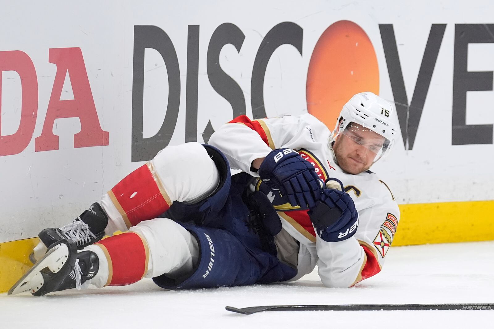 Florida Panthers center Aleksander Barkov tries to get up after getting knocked down by Tampa Bay Lightning left wing Brandon Hagel during the third period in Game 2 of an NHL hockey Stanley Cup first-round playoff series, Thursday, April 24, 2025, in Tampa, Fla. (AP Photo/Chris O'Meara)