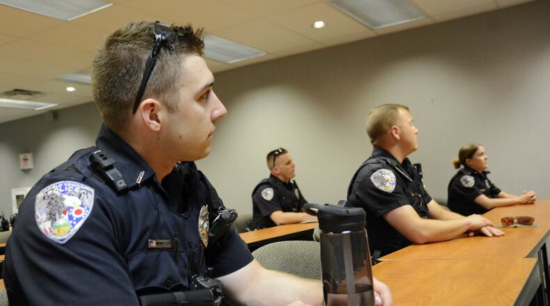 Fairfield Twp. police Officer John Boyer sits with other officers in the daily briefing on July 3, 2019, before the start of the second shift. Many departments around the region are bringing on younger officers as older officers leave or retire. MICHAEL D. PITMAN/STAFF