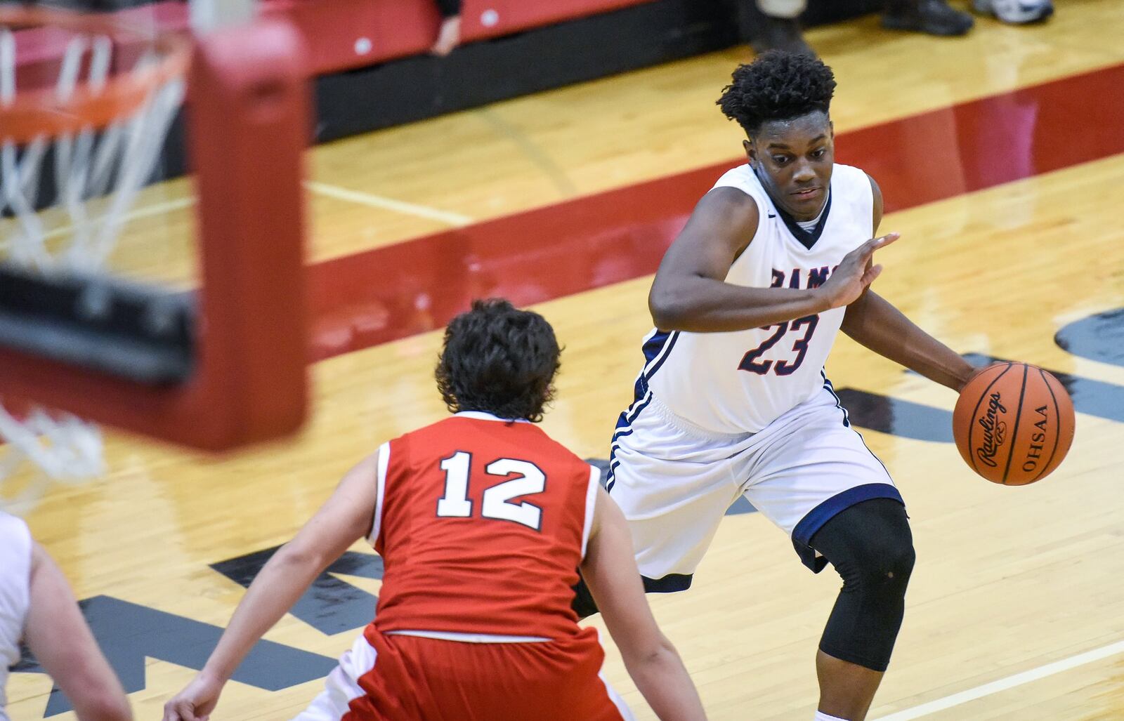 Miami Valley’s Lennox Roberts is eyed by Madison’s Ethan Limon (12) on Thursday night during the Brian Cook Classic at Madison. NICK GRAHAM/STAFF