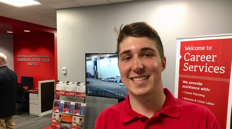 Miami University Middletown senior Austin Philpot says he is impressed with the just-opened William & Patricia Schaefer Career Services Suite in Johnston Hall. The new suite will be a one-stop shop for students at the school who have career questions or need career research and preparation help, Miami officials said during opening ceremonies. (Photo by Michael D. Clark/Journal-News)