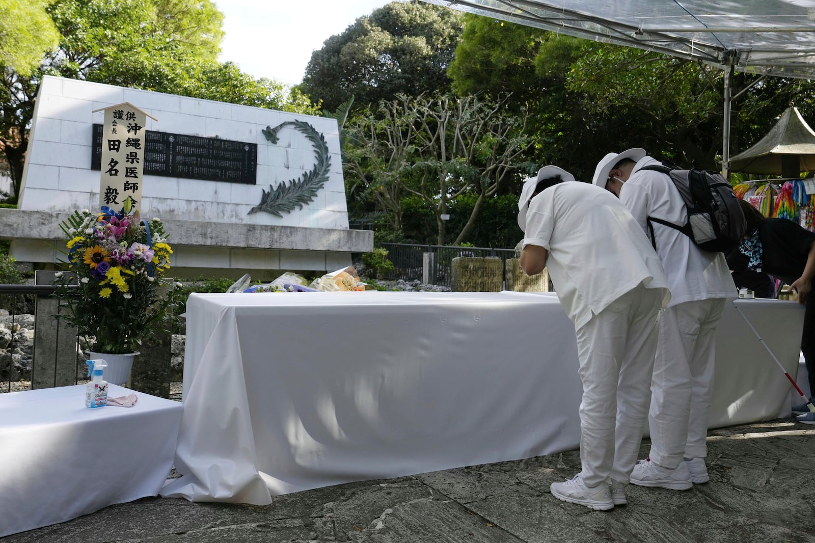 People pray in front of the Himeyuri Cenotaph in Itoman, Okinawa, southern Japan Monday, June 23, 2025 as Japan marked the 80th anniversary of the end of the Battle of Okinawa. (Naoki Hiraoka/Kyodo News via AP)
