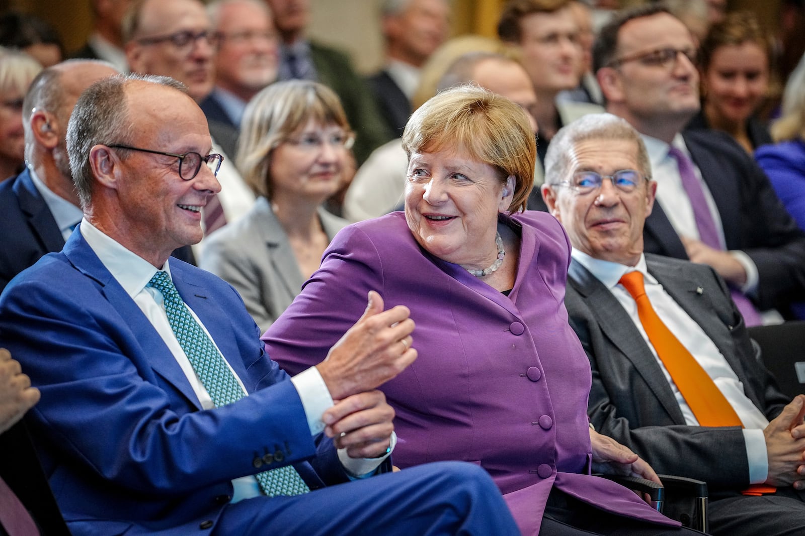 FILE - Former German Chancellor Angela Merkel and CDU Federal Chairman and CDU parliamentary group leader Friedrich Merz, left, take part in the Berlin special discussion on the former Chancellor's 70th birthday, in Berlin, Sept, 25, 2024. (Kay Nietfeld/dpa via AP)