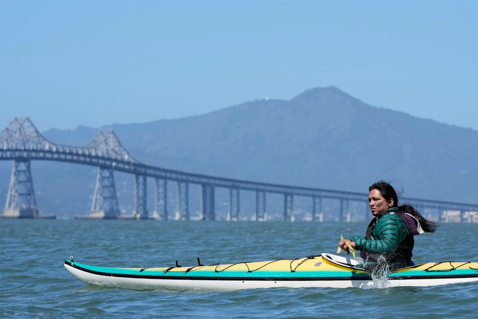 Juan Bay, president of the Waorani people of Ecuador, kayaks in the San Francisco Bay toward the Chevron Long Wharf, Thursday, June 19, 2025, in Richmond, Calif. (AP Photo/Godofredo A. Vásquez)