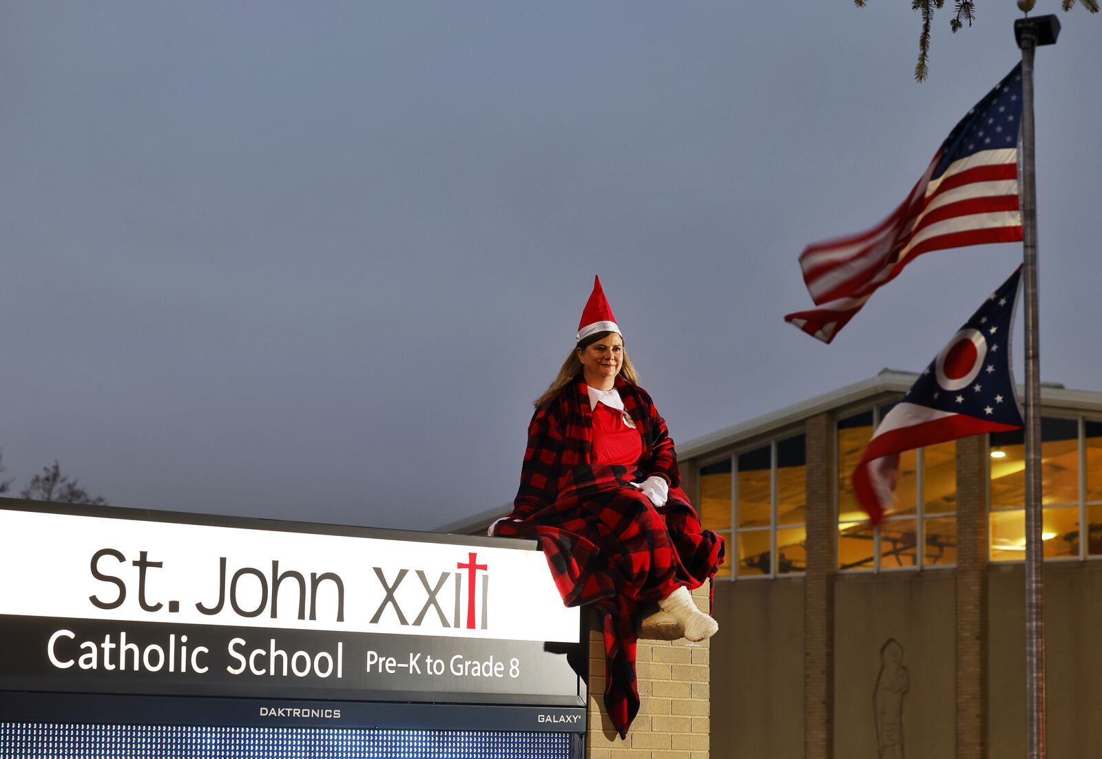 Dawn Pickerill, Principal of St. John XXIII Catholic School in Middletown, has been posing as "Elf on the Shelf" in different areas around the school in the mornings as students arrive. NICK GRAHAM/STAFF