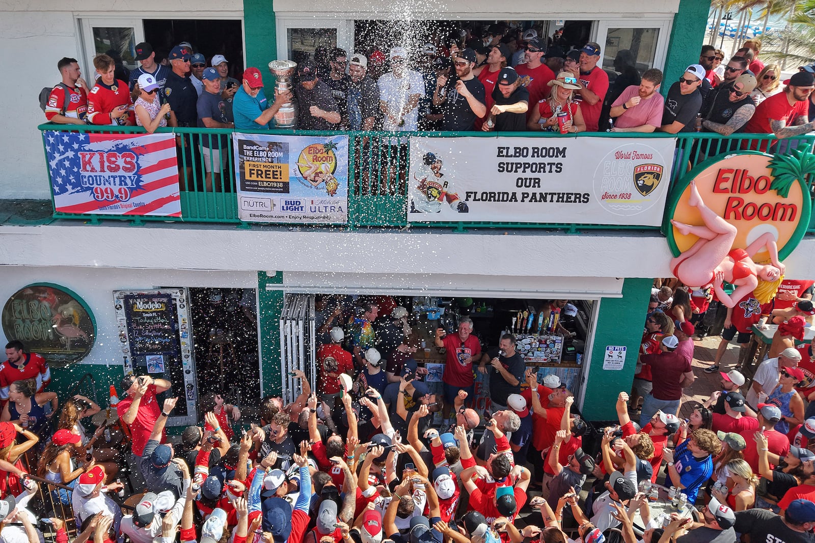 Members of the Florida Panthers hockey team celebrate with fans outside the Elbo Room, Wednesday, June 18, 2025, in Fort Lauderdale, Fla., the morning after defeating Edmonton in Game 6 of the Stanley Cup Final. (Amy Beth Bennett/South Florida Sun-Sentinel via AP)