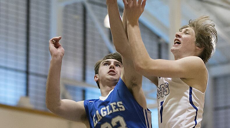Cincinnati Christian’s Riley Reutener has his shot challenged by Middletown Christian’s Jarod Hamlin during the All-Butler County All-Star boys basketball game at the Hamilton Athletic Center in Hamilton on April 7, 2018. CONTRIBUTED PHOTO BY E.L. HUBBARD