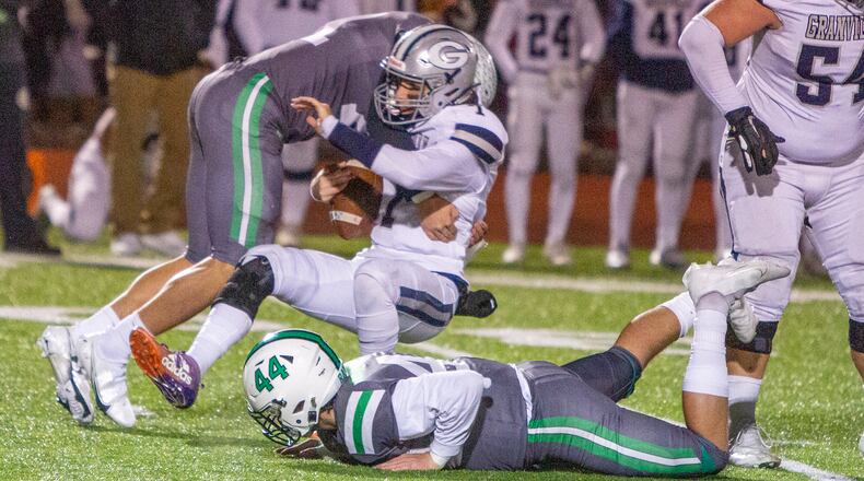 Badin's Logan Neu and Jackson Martin (44) sack Granville quarterback Carsyn Crouch in the first half of Friday night's 14-0 state semifinal win. Jeff Gilbert/CONTRIBUTED
