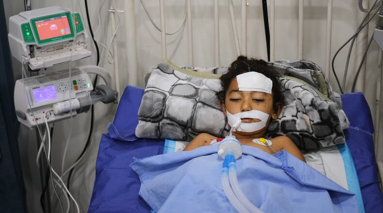 Nabila Shorbasi, who was injured by an unexploded ordnance along with her six-year-old twin brother Yahya, lies on a bed at Patient's Friends Charity Hospital in Gaza City, Saturday, Oct. 25, 2025. (AP Photo/Abdel Kareem Hana)