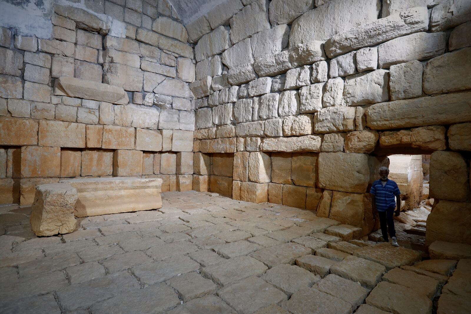 A worker stands on a dry reservoir of the Ein el-Fijeh spring, in the Barada Valley, Syria, Thursday, May 8, 2025. The Ein el-Fijeh spring, the main water source for Damascus, has nearly dried up, forcing many residents in the capital and its suburbs to rely on water delivered by tanker trucks that fill from local wells. (AP Photo/Omar Sanadiki)