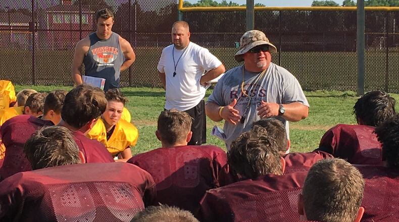 Ross coach Kenyon Commins talks to his team after practice at the school Monday. RICK CASSANO/STAFF