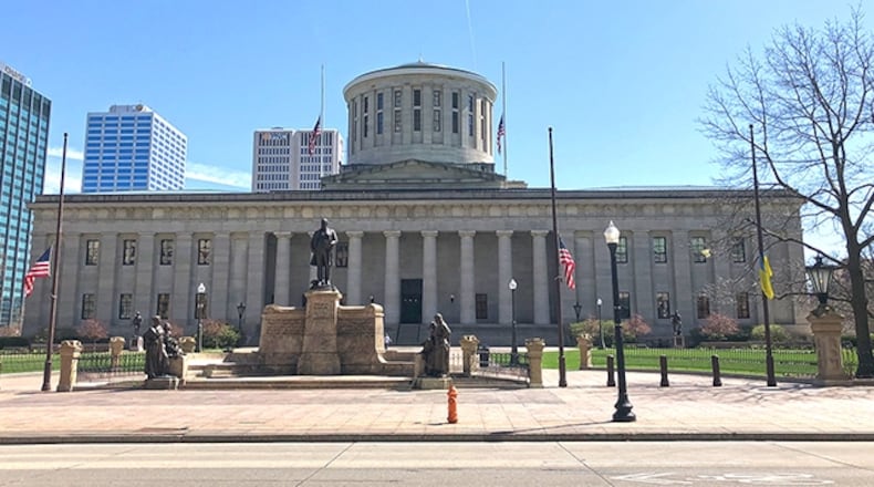 Flags fly at half staff in front of the Ohio Statehouse.