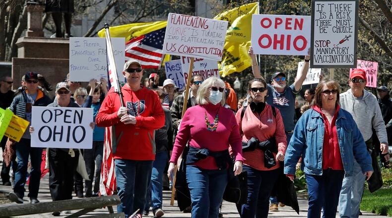Protesters gather outside of the Ohio State House in Columbus, Ohio, Monday, April 20, 2020, to protest the stay home order that is in effect until May 1. (AP Photo/Gene J. Puskar)