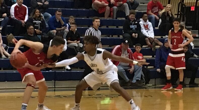 Lakota East’s Jalen Peck (44) guards La Salle’s Derek Eddings (13) on Friday night during a Division I sectional final at the Hamilton Athletic Center. RICK CASSANO/STAFF