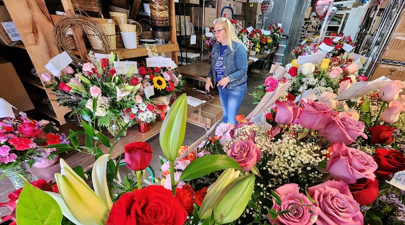 Amanda Reed organizes outgoing Valentine's Day flower orders at Flowers By Roger in Middletown. NICK GRAHAM/STAFF
