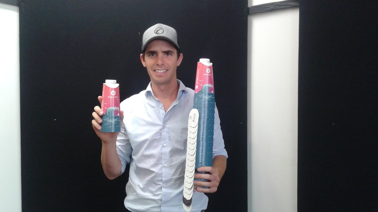 Scott Edwards of Drop Water shows containers used by his water-dispensing machines that sell the liquid in a more environmentally friendly way.