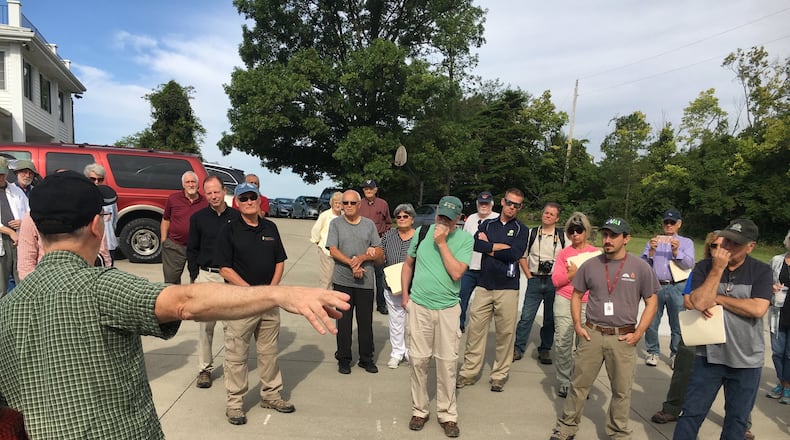 Top state archaeologists and historians were among those who gathered in late August to visit the 2,000-year-old Hopewell earthworks in Ross Township known as the Fortified Hill works. Before walking about half a mile to the site, they heard a description of the property, which will be auctioned for an estate settlement Sept. 28. MIKE RUTLEDGE/STAFF