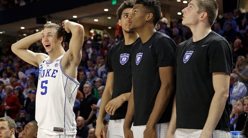 Duke players including Luke Kennard (5) watch the final minutes of the second half of a second-round game against South Carolina in the NCAA men’s college basketball tournament in Greenville, S.C., Sunday, March 19, 2017. South Carolina upset Duke 88-81. (AP Photo/Chuck Burton)