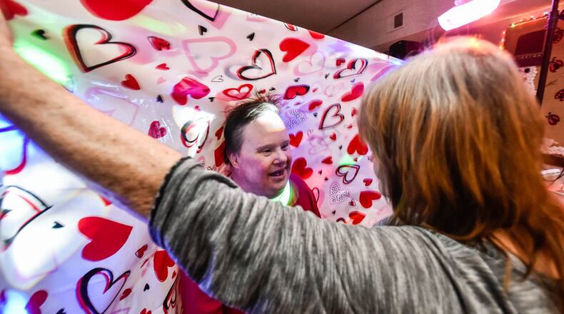 Program manager Vickie Rogers, right, dances with Sandi during the first Ability to Thrive Valentine’s Day dance held Friday, Feb. 14, 2020 at the Ability to Thrive building on Joe Nuxhall Way in Fairfield. NICK GRAHAM / STAFF