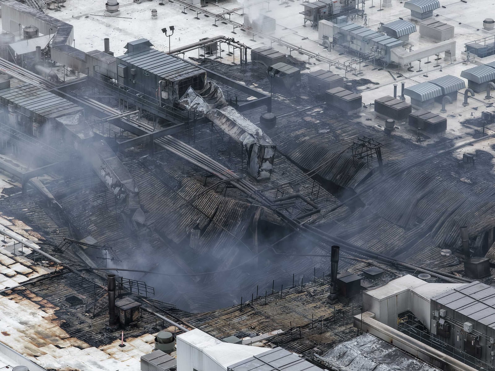 A large industrial fire at Koch Foods Plant B on Commerce Center Drive in Fairfield let to a roof collapse. NICK GRAHAM/STAFF