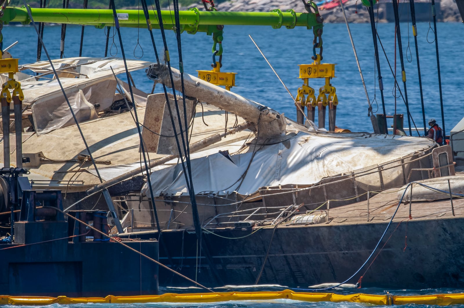 The hull of the superyacht Bayesian, which sank near Palermo, Sicily, on August 19, 2024, is pulled out of the sea off the village of Porticello and dewatered, Saturday, June 21, 2025. (AP Photo/Salvatore Cavalli)