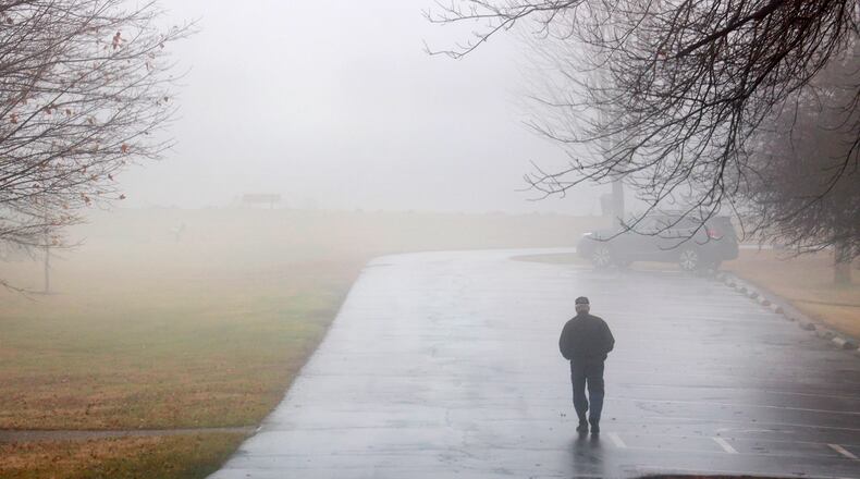 A man walks in the dense fog at C.J. Brown Reservoir Thursday, Jan. 12, 2023. The fog around the reservoir obscured the water and made driving difficult. BILL LACKEY/STAFF