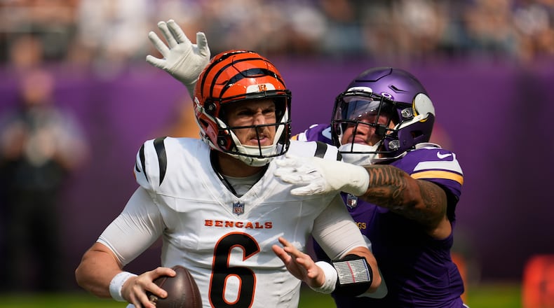 Cincinnati Bengals quarterback Jake Browning (6) is chased by Minnesota Vikings linebacker Ivan Pace Jr. during the first half of an NFL football game, Sunday, Sept. 21, 2025, in Minneapolis. (AP Photo/Mike Stewart)
