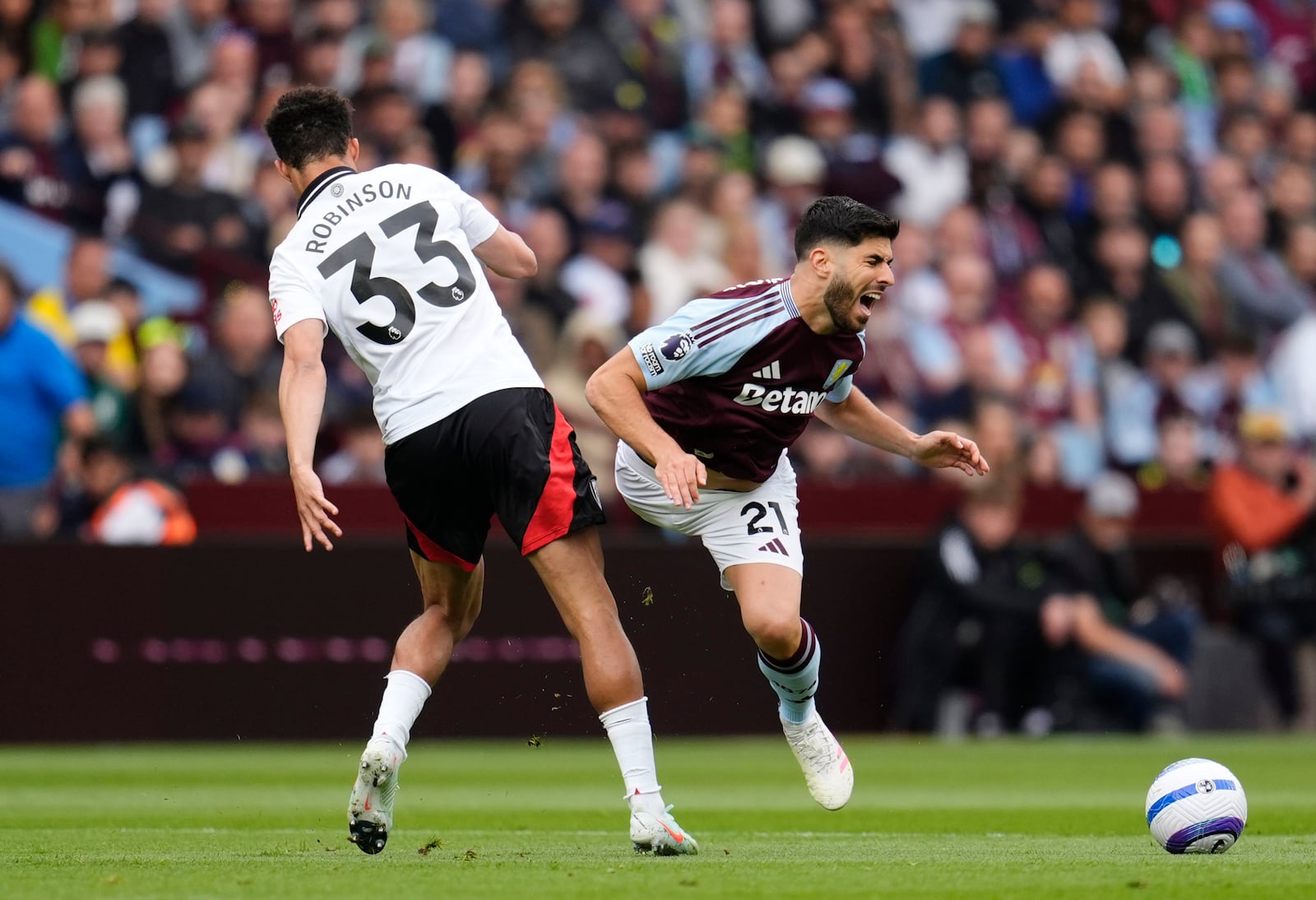 Fulham's Antonee Robinson, left, and Aston Villa's Marco Asensio battle for the ball during the English Premier League soccer match between Aston Villa and Fulham at Villa Park, Birmingham, England, Saturday, May 3, 2025. (Nick Potts/PA via AP)