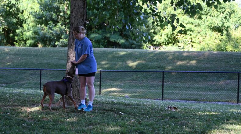 A group of citizens, with the backing of the city of Fairfield, are seeking to install a Rainbow Bridge, a structure that would be a memorial for pet owners to honor, remember and say good-bye to their loved ones. The Rainbow Bridge has been developed in other states and is based on a poem of the same name. Pictured is Alli McGrinder, of West Chester Twp., with Winnie, her 7-month-old Doberman, at the River Road park on Monday, June 24, 2024. MICHAEL D. PITMAN/STAFF
