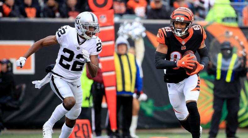CINCINNATI, OH - DECEMBER 16: Tyler Boyd #83 of the Cincinnati Bengals catches a pass while being defended by Rashaan Melvin #22 of the Oakland Raiders during the first quarter at Paul Brown Stadium on December 16, 2018 in Cincinnati, Ohio. (Photo by Andy Lyons/Getty Images)