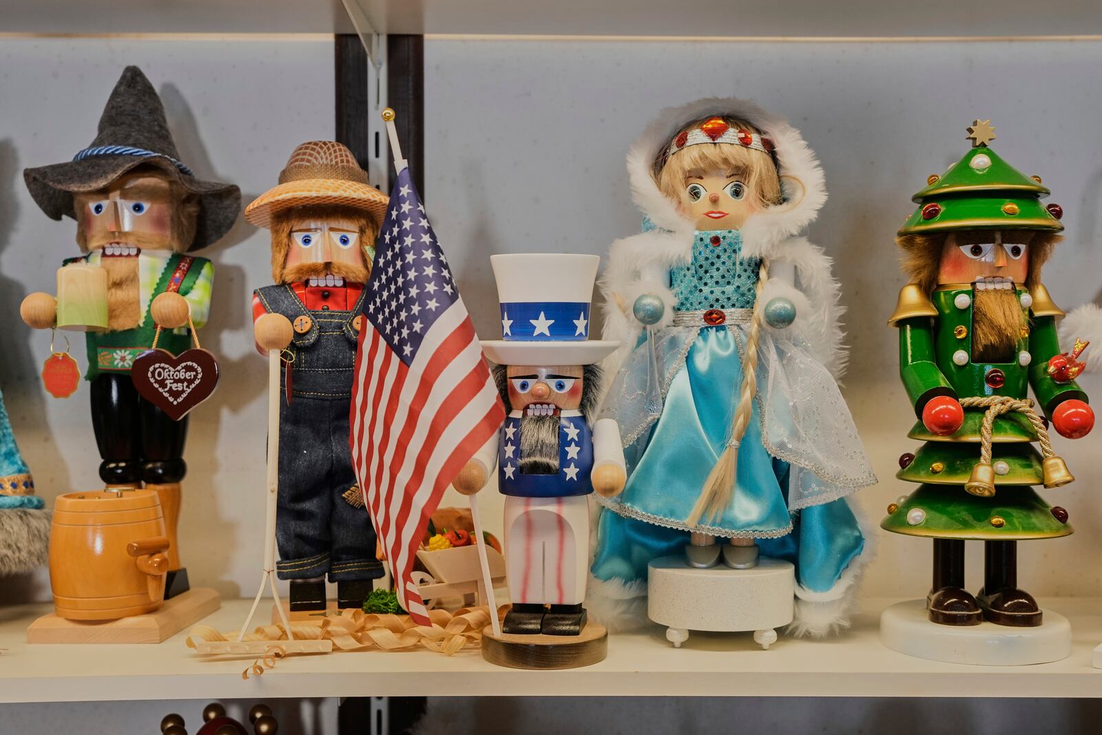 An Uncle Sam nutcracker with an American flag, center, stands between other nutcrackers at the Steinbach-Volkskunst nutcracker factory in Marienberg, Germany, Tuesday, April 15, 2025. (AP Photo/Markus Schreiber)