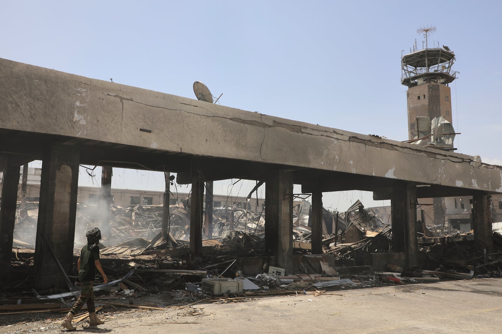 A Yemeni officer inspects the damage following Israeli airstrikes on Sanaa International Airport in Sanaa, Yemen, Wednesday, May 7, 2025. (AP Photo/Osamah Abdulrahman)