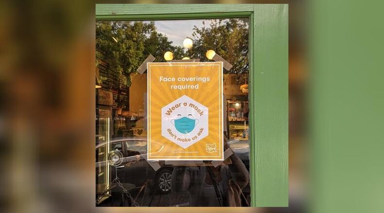 Signs such as this one on the door of La Bodega restaurant, 11 W. High St., were distributed through the city to businesses all over town after city council passed a mask mandate. OXFORD OBSERVER