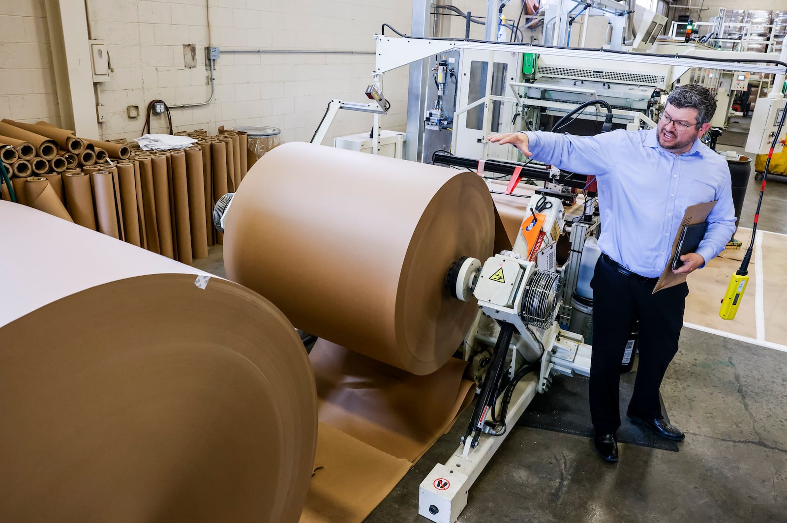 Plant manager Jeremy Nagele gives a tour of Eco Pack on Donald Drive in Fairfield after their ribbon cutting Thursday, May 30, 2024. The facility produces paper bags for multiple companies including Amazon. NICK GRAHAM/STAFF
