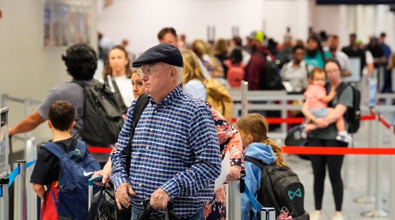 Travelers stand in line at a ticketing gate at the Dallas Fort Worth International Airport, at DFW Airport, Texas, Friday, Nov. 21, 2025. (AP Photo/Tony Gutierrez)