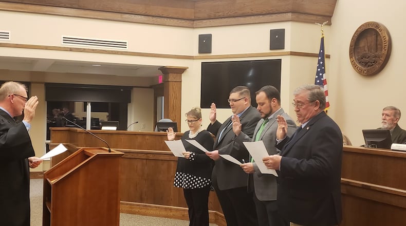 Judge Robert Hendrickson of the Ohio 12th District Court of Appeals, left, administers the oaths of office Jan. 2 to Monroe City Council members Christina McElfresh, Jason Frentzel, Keith Funk and Tom Callahan as Mayor Robert Routson, far right, looks on. After the council members were sworn-in, Frentzel was selected as mayor and Funk was selected as vice mayor. CONTRIBUTED/CITY OF MONROE