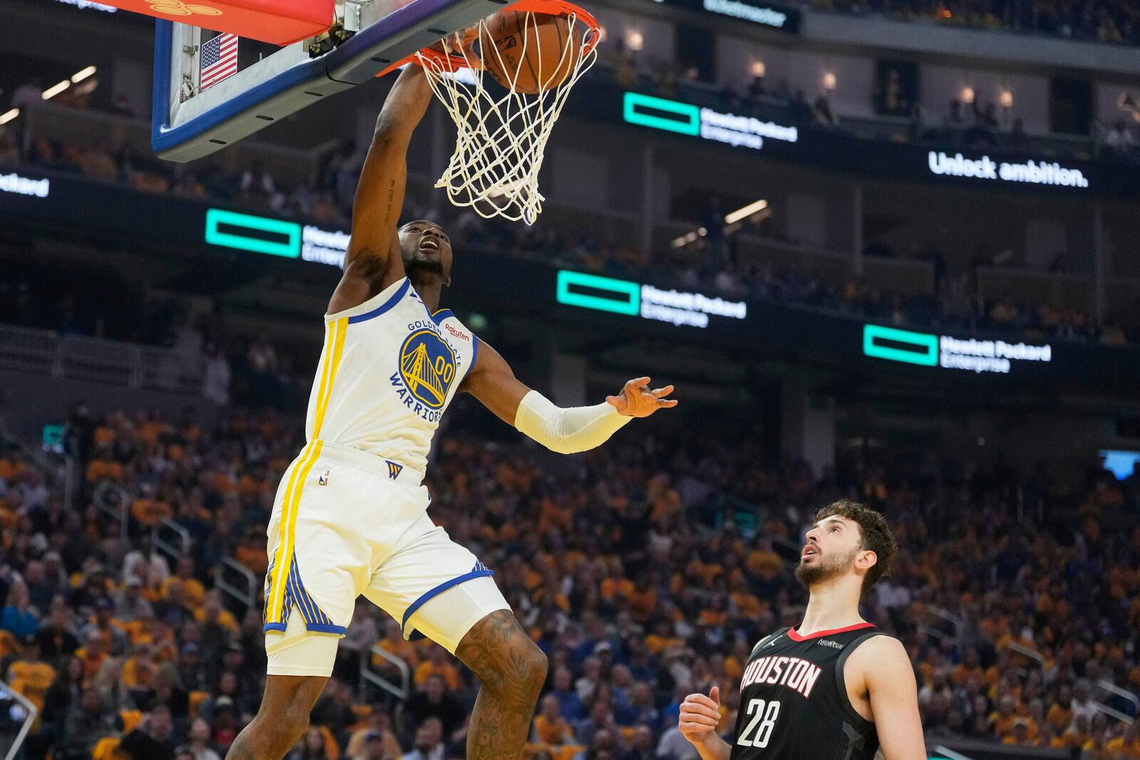 Golden State Warriors forward Jonathan Kuminga (00) dunks over Houston Rockets center Alperen Sengun (28) during the first half of Game 3 of an NBA basketball first-round playoff series in San Francisco, Saturday, April 26, 2025. (AP Photo/Jeff Chiu)
