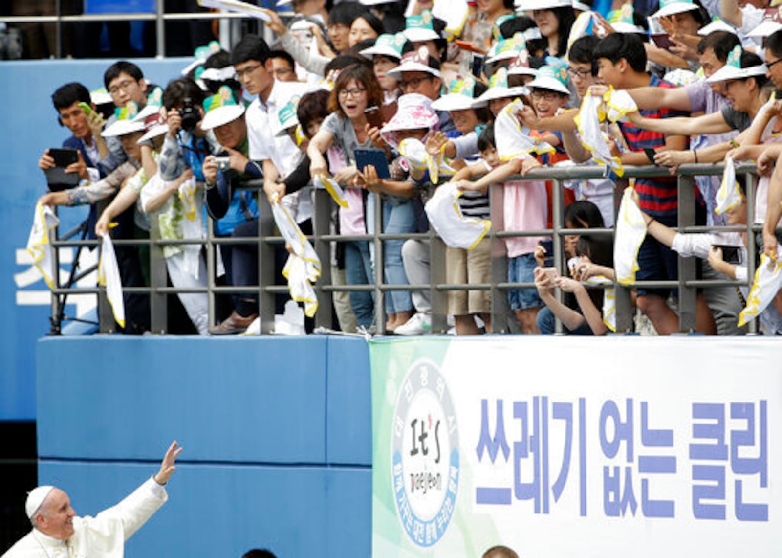 FILE - Pope Francis blesses faithfuls as he arrives to celebrate the Mass of Assumption of Mary at Daejeon World Cup stadium in Daejeon, South Korea, Friday, Aug. 15, 2014. (AP Photo/Gregorio Borgia, file)