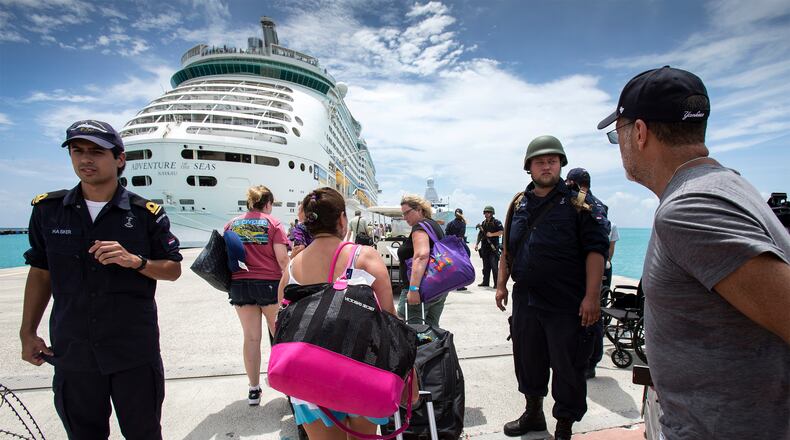 This photo provided by the Dutch Defense Ministry on Sunday, Sept. 10, 2017, shows people walking toward a cruise ship anchored on St. Maarten, after the passage of Hurricane Irma. Irma cut a path of devastation across the northern Caribbean, including this island that is split between French and Dutch control. (Gerben Van Es/Dutch Defense Ministry via AP)