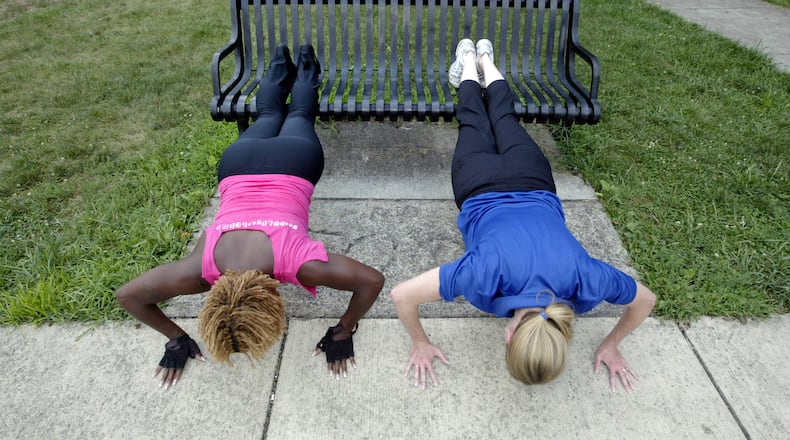 Jackie Brockman, associate executive director of the Trotwood YMCA, helps train Nashanda Peeples on exercises that can be performed in just about any urban environment. The urban landscape, from parks and playgrounds to stadium steps or bleachers, can provide opportunities for cardiovascular and muscle-conditioning workouts. You can do push-ups on a park bench. A parking lot and its concrete pylons can provide both interval training and muscle conditioning.