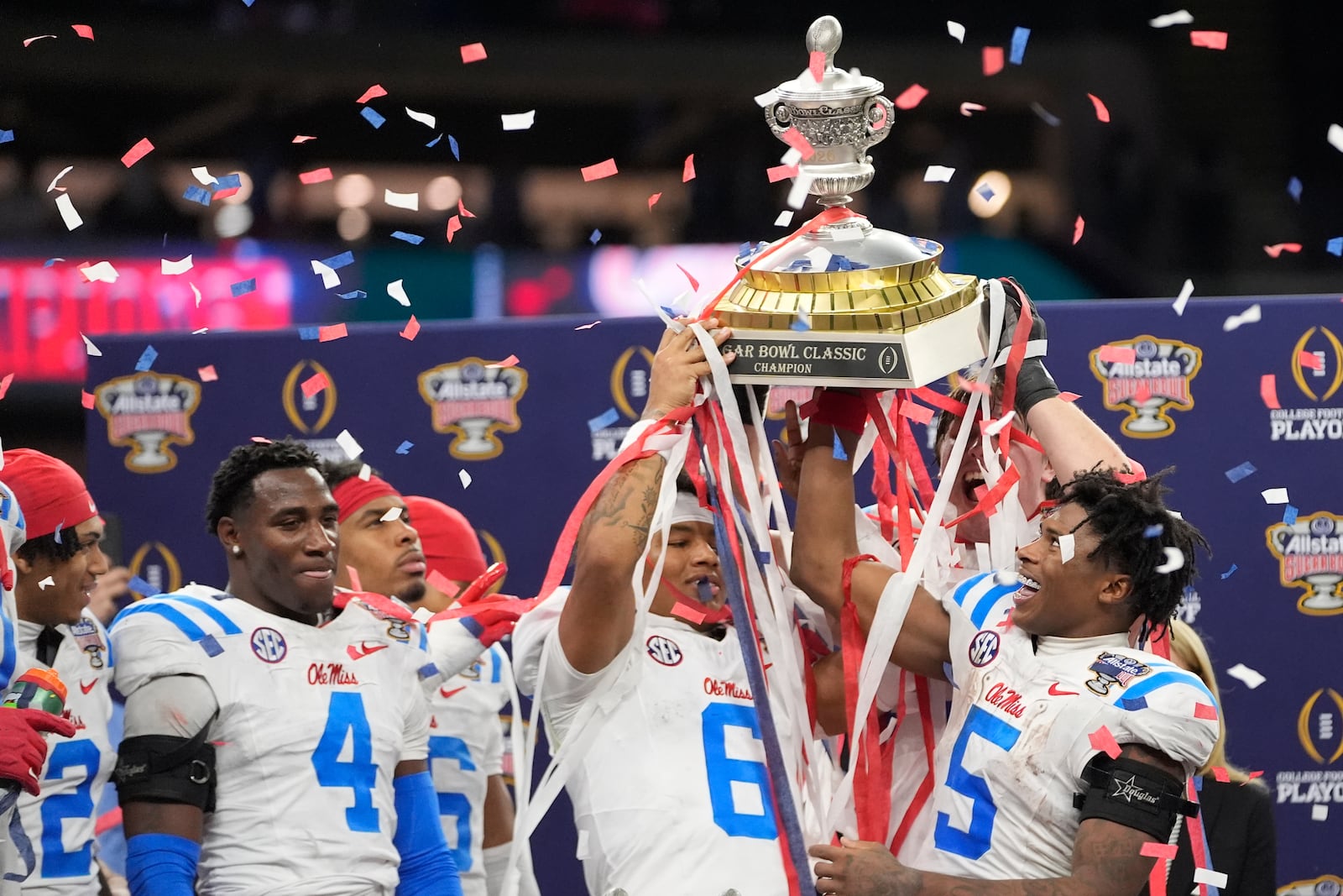 Mississippi platers and coach celebrate a win against Georgia after the Sugar Bowl NCAA college football playoff quarterfinal game, Friday, Jan. 2, 2026, in New Orleans. (AP Photo/Gerald Herbert)
