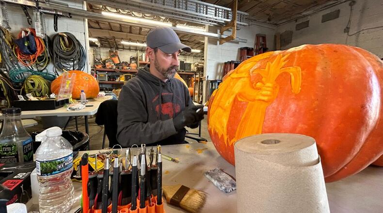 Shannon Gerasimchik works on his tenth pumpkin on the week. ANDREW ROWAN/WCPO